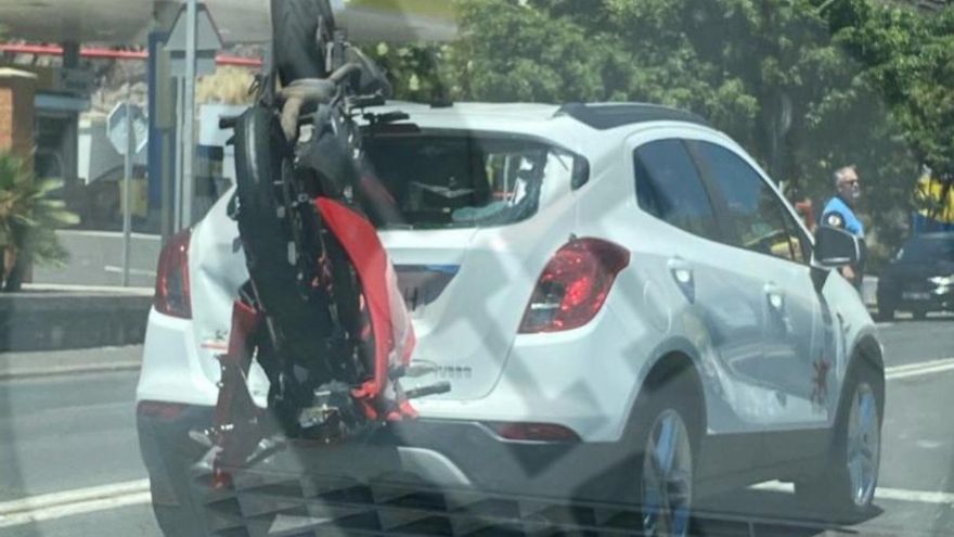 a motorcycle crashes into a car