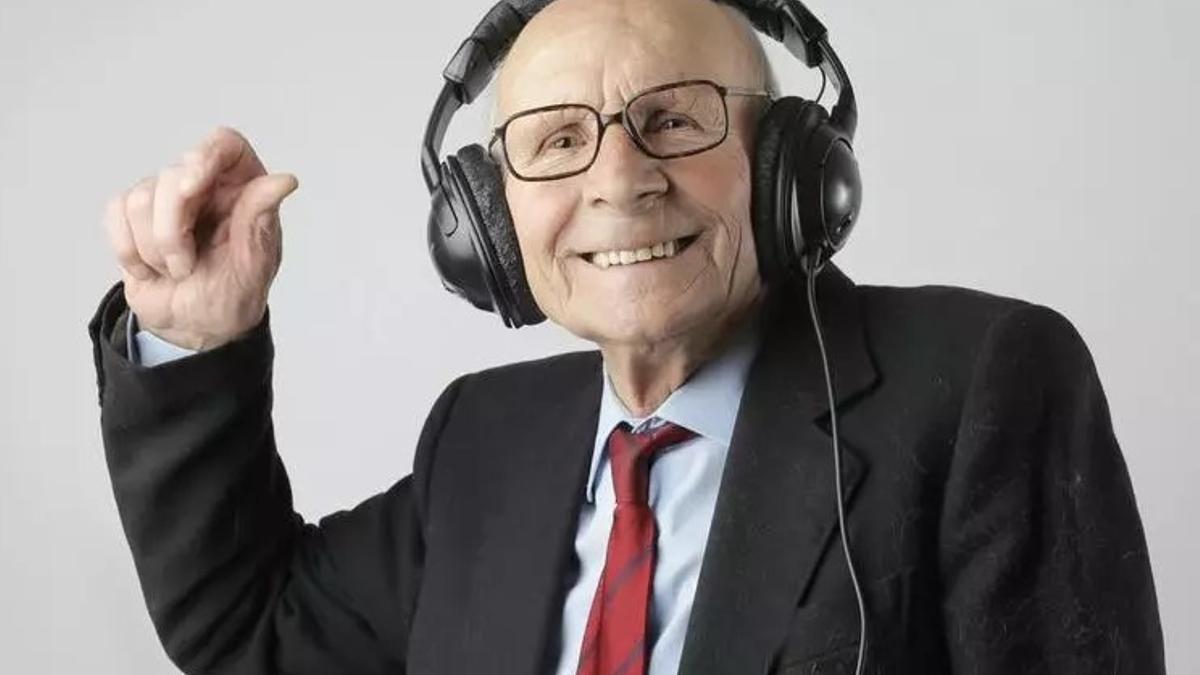 Una persona mayor disfrutando de la música.