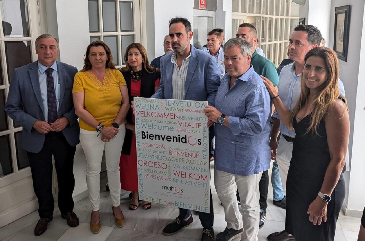 Los representantes de la Asociación de Hosteleros de Málaga (Mahos) y de algunas instituciones, con el cartel de bienvenida al turista.