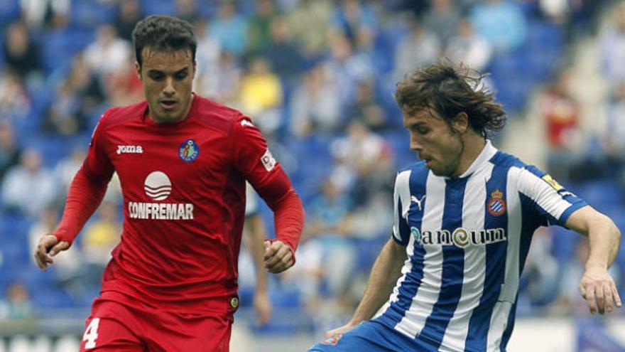 Joaquim Verdu (d), del RCD Espanyol, intenta controlar el balón ante la oposición de Pedro León (i), del Getafe CF, durante el partido de Liga disputado este mediodía en el Estadio de Cornellà.