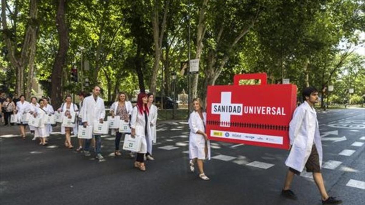 Activistas reclaman sanidad pública para los simpapeles, ayer en Madrid, frente al ministerio.