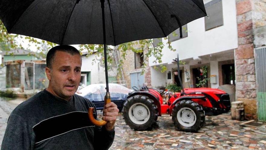 José Miguel Suárez Álvarez, hijo del fallecido, ayer, junto al tractor a la puerta del domicilio familiar.