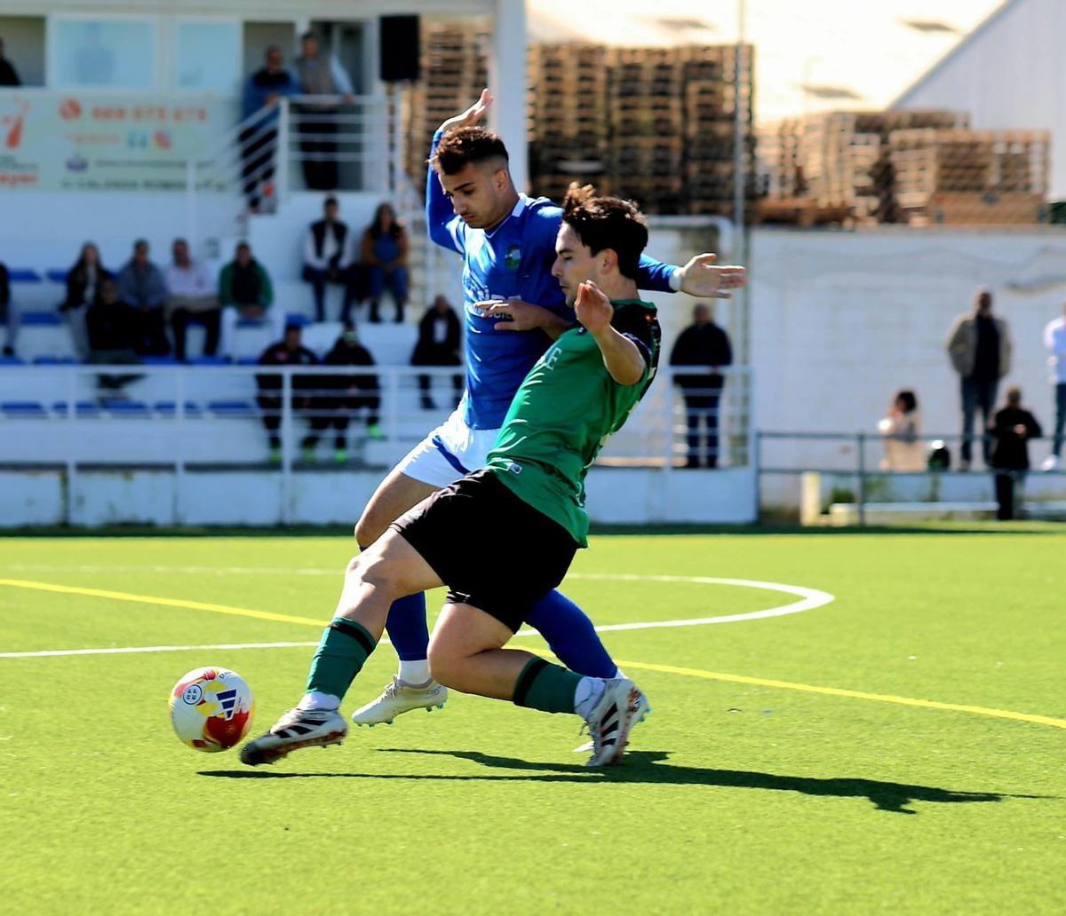 Adolfo trata de hacerse con el balón ante un contrario.