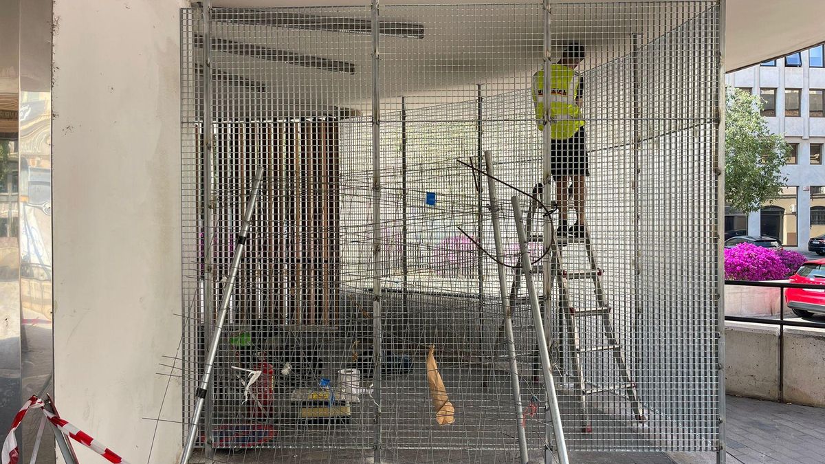Un operario concluye la instalación del cerramiento metálico donde dormían los sin techo  en la plaza Comtat del Rosselló de Palma