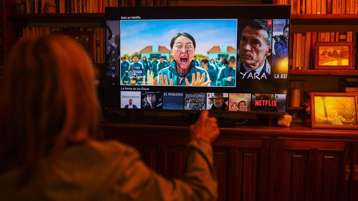 Una mujer busca películas en Netflix