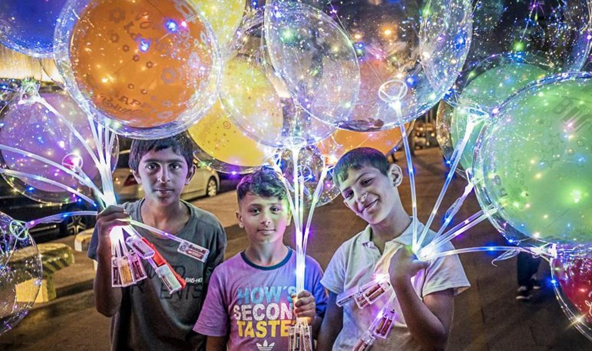 From left to right, Ali 15 years old, Kasem 12 years old and Abed 11 years old, balloon sellers during the night, child labour, syrian refugees, Corniche, Beirut, Lebanon