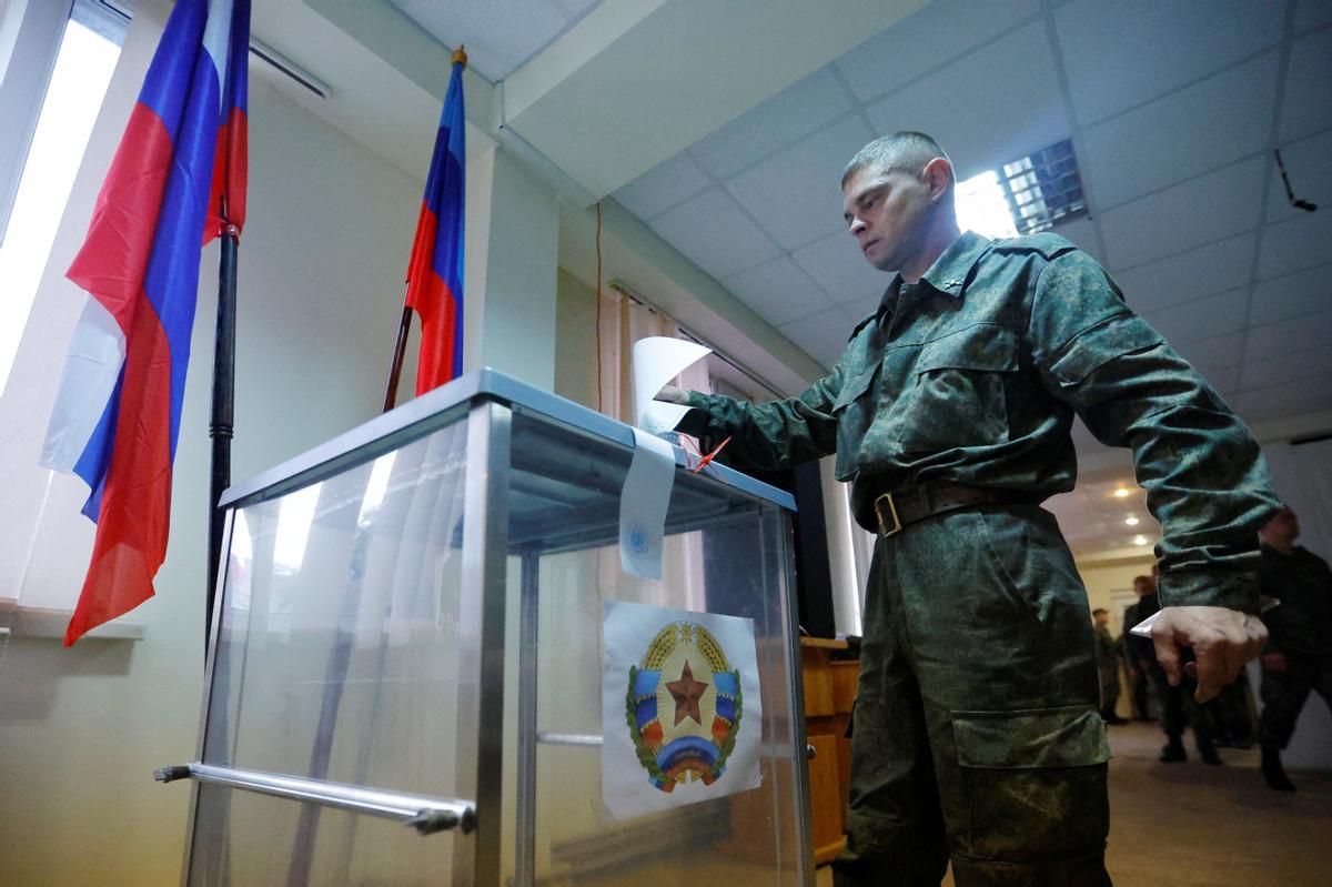Service members of the self-proclaimed Luhansk Peoples Republic vote during a referendum in Luhansk