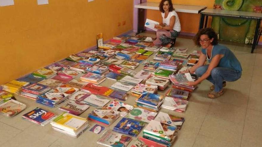 Voluntarias con numerosos tomos en el banco de libros de Teis. //FdV