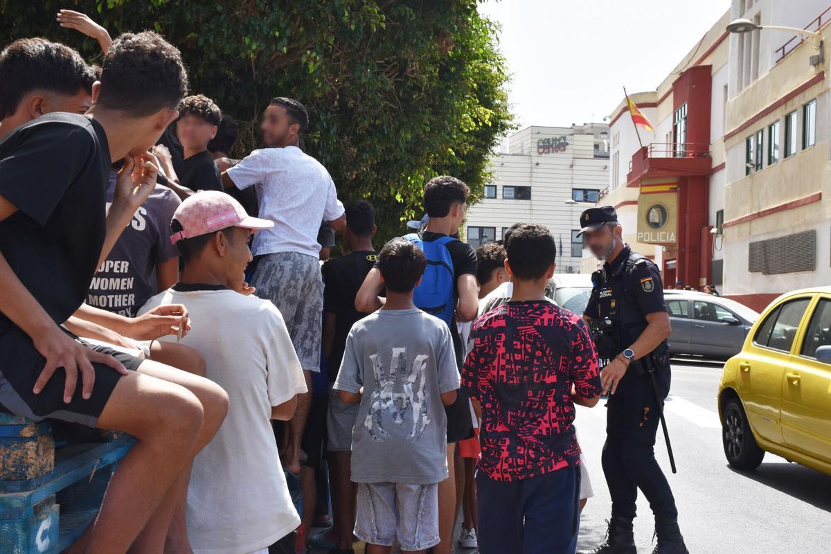 Un grupo de menores espera para ser filiado en una comisaría de la Policía Nacional de Ceyta este lunes.