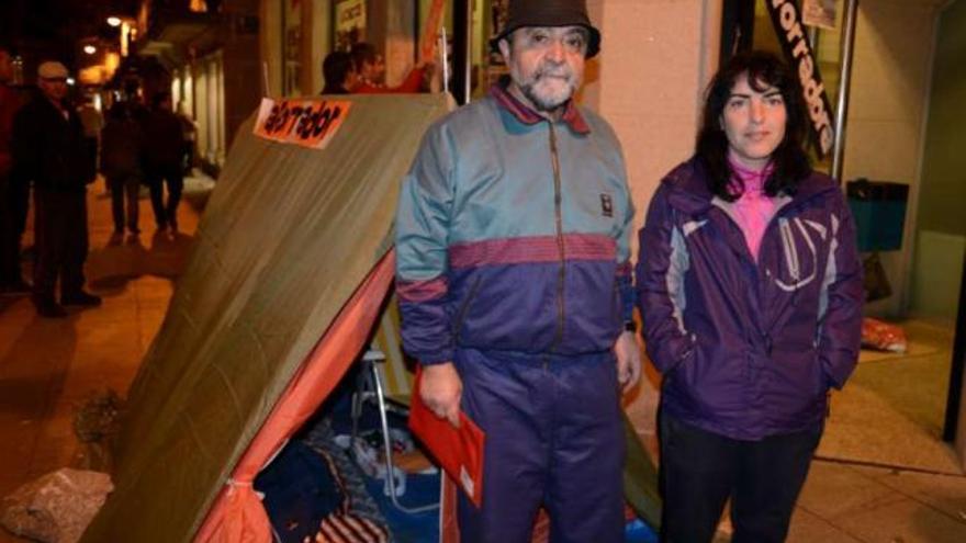 Antonio Graña y Sonia Pardo, ante la tienda de campaña delante del banco en Cangas.  // Gonzalo N.