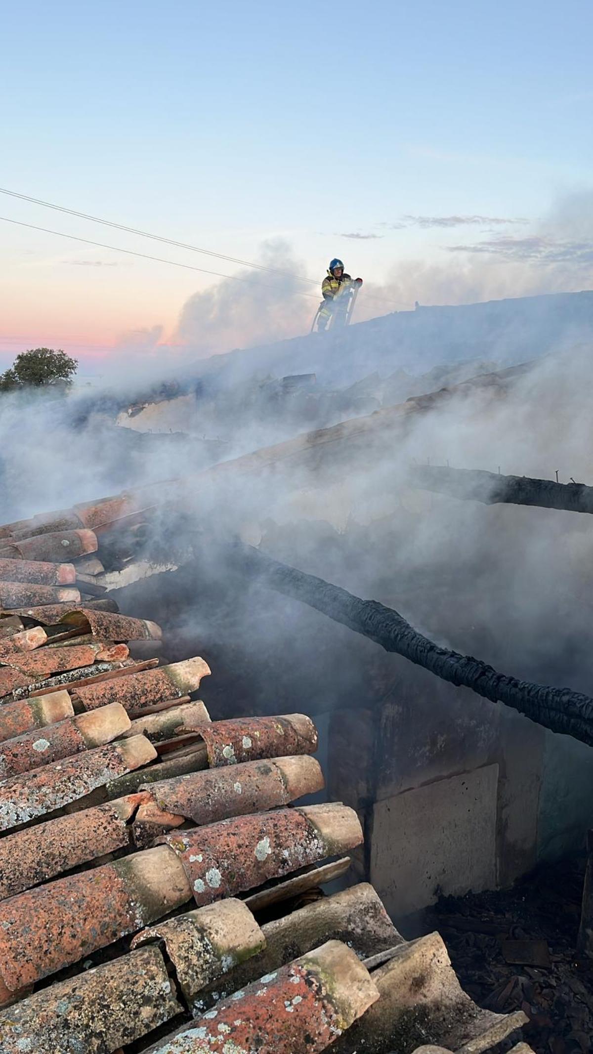 Un bombero accede al tejado del edificio en el que se ha registrado el incendio.