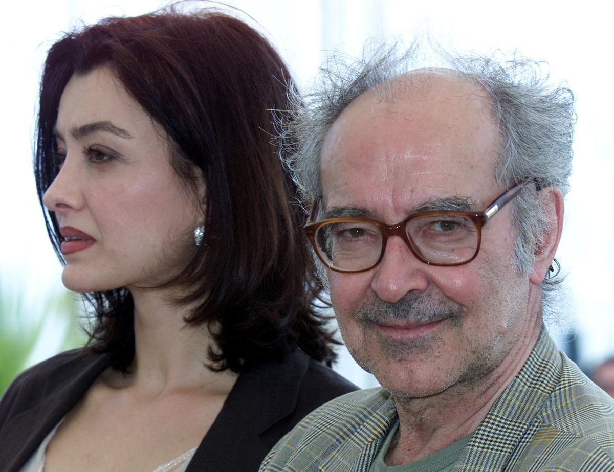 FILE PHOTO: Swiss director Jean Luc Godard (R) smiles as he stands with actress Cecile Camp (L) for their film ..