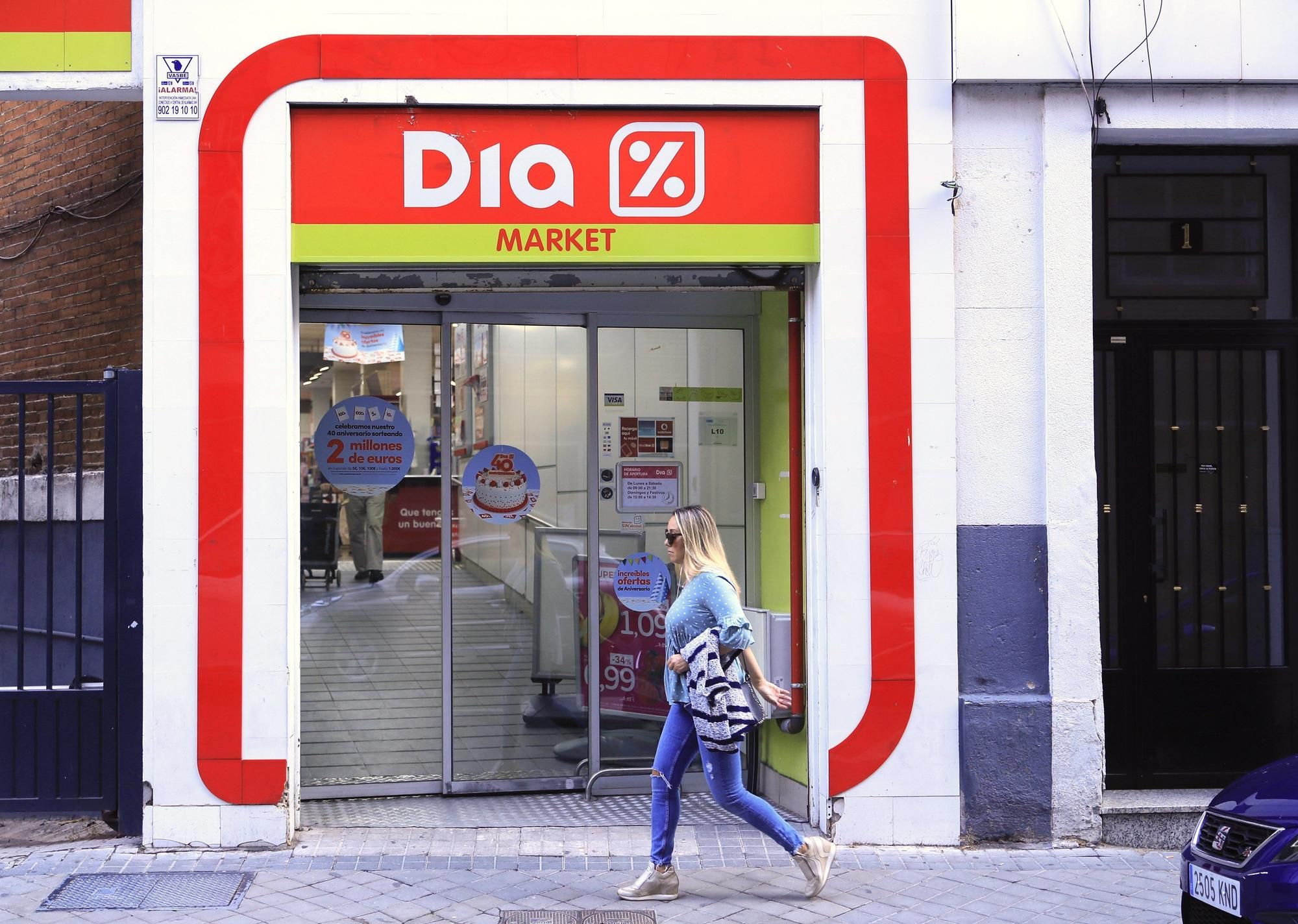 Una joven pasa junto a un supermercado Dia.