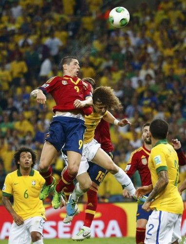 Spain's Torres and Ramos fight for the ball with Brazil's Luiz during their Confederations Cup final soccer match at the Estadio Maracana in Rio de Janeiro