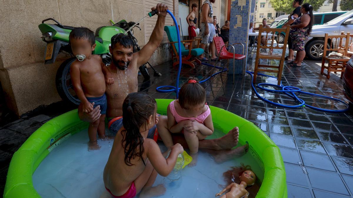 Una familia sobreviviendo al calor este verano en el barrio valenciano de Fuensanta.