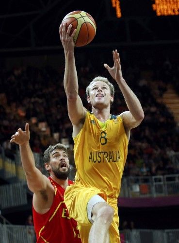 Australia's Patrick Mills goes to the basket against Spain's Marc Gasol during the men's preliminary round Group B basketball match at the Basketball Arena during the London 2012 Olympic Games