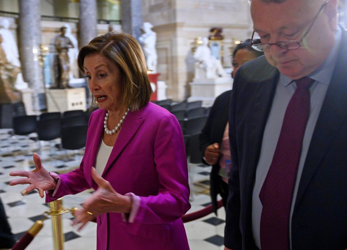 US speaker of the House  Nancy Pelosi   D-CA   L  walks to her office  before the Democrat controlled House of Representatives passed a resolution condemning US President Donald Trump for his  racist comments  about four Democratic congresswomen the day before   at the Capitol in Washington  DC on July 16  2019   Photo by ANDREW CABALLERO-REYNOLDS   AFP