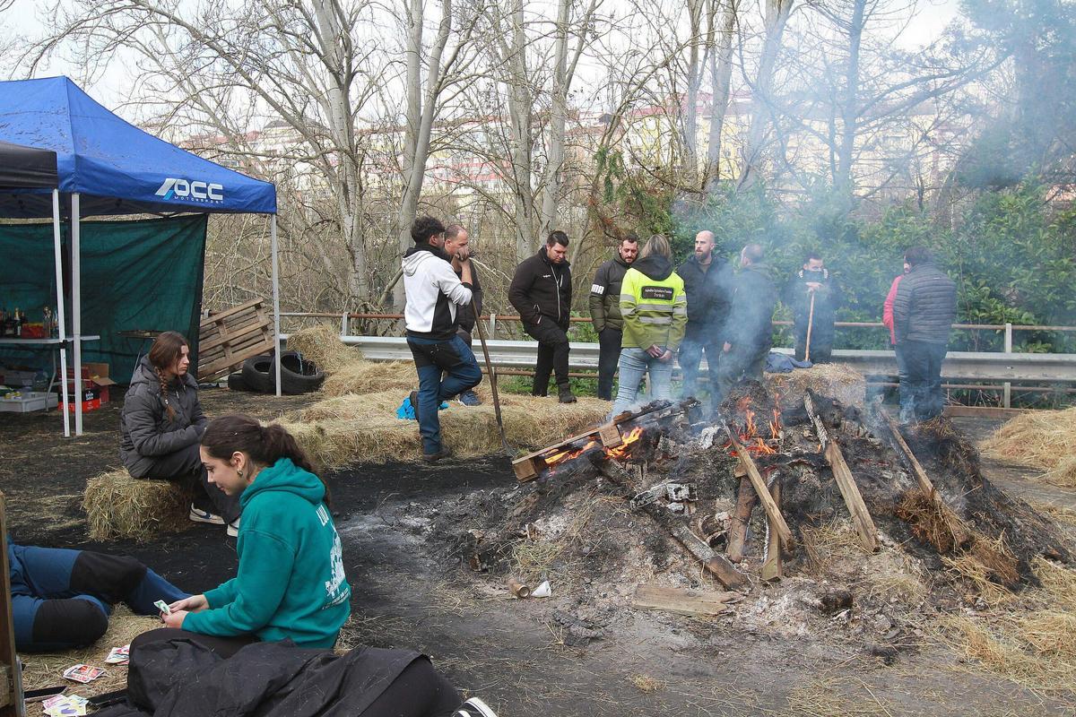 Conservaciones y juegos de cartas para pasar las horas en el punto de movilización en la N-120 en Ourense.