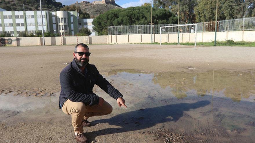 Rafael Merino, portavoz de la junta directiva del CD Miraflores-Gibraljaire, muestra el estado del campo, el único de tierra que queda en Málaga.