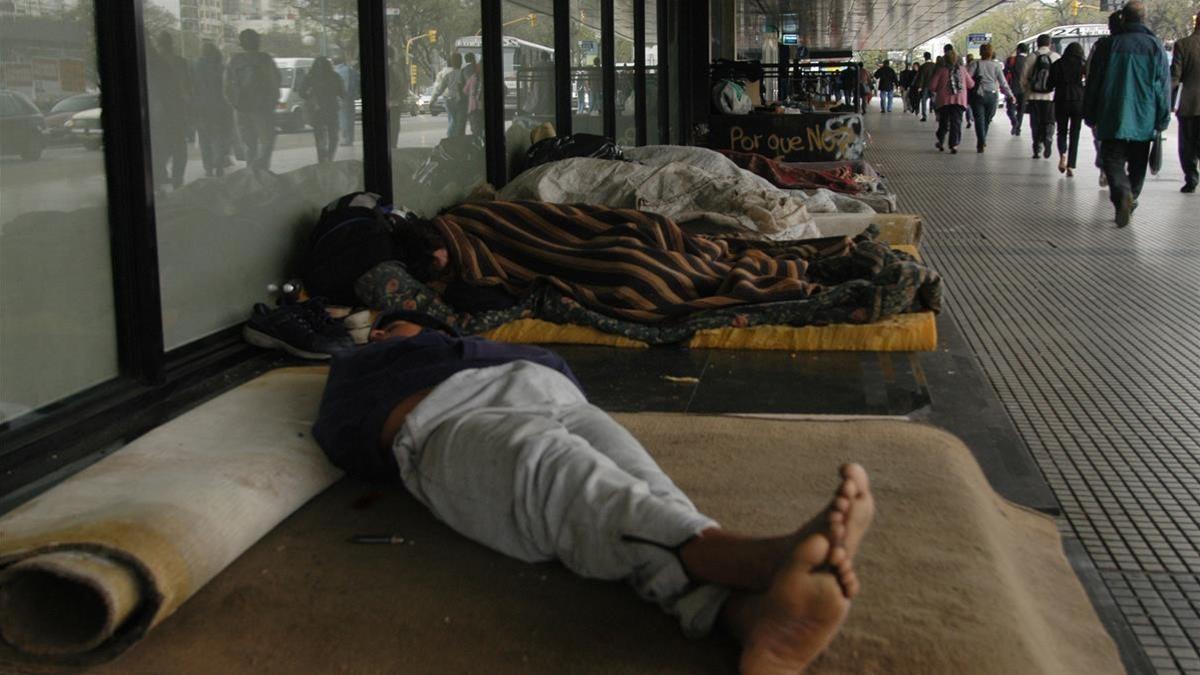 Varias personas duermen en la calle en Buenos Aires.