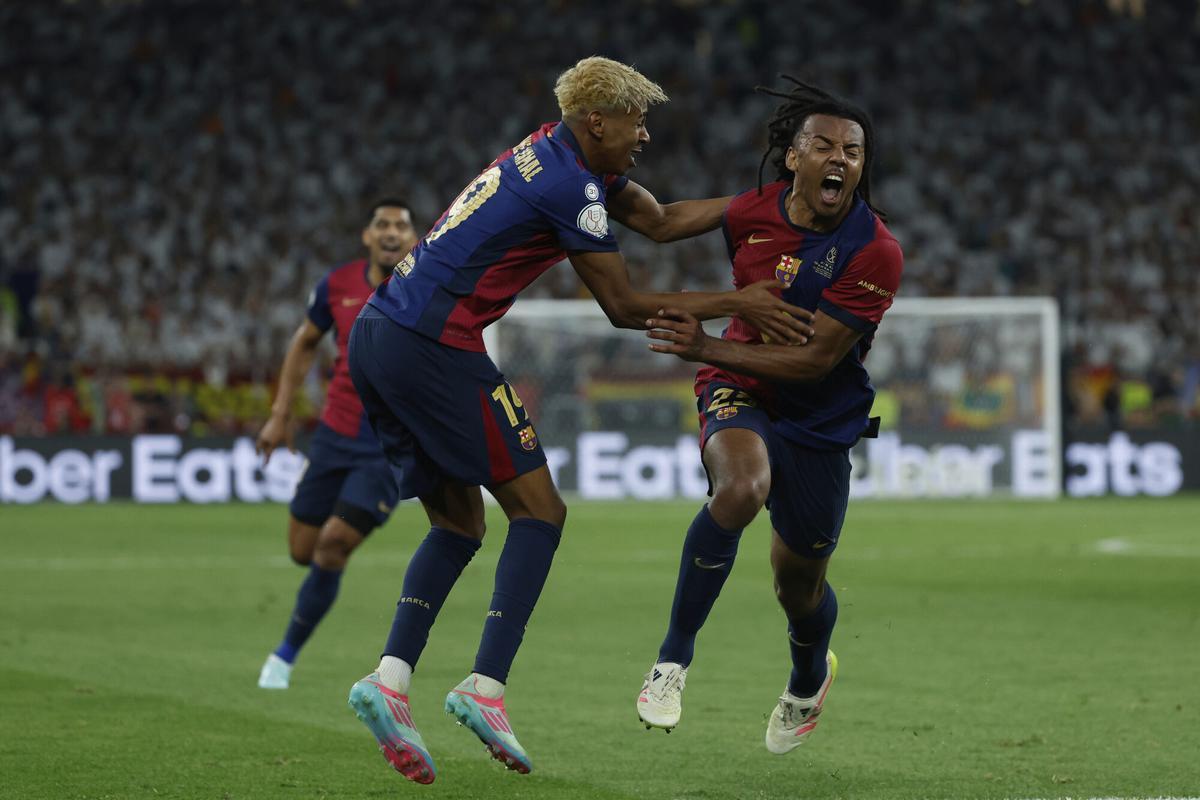 Barcelona's Jules Kounde, right, celebrates after scoring his side's third goal during the Spanish Copa del Rey final soccer match between Barcelona and Real Madrid at Estadio de La Cartuja stadium in Seville, Spain, Sunday, April 27, 2025. (AP Photo/Joan Monfort)