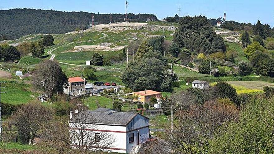 Vistas del núcleo rural del castro de Elviña, con el yacimiento arqueológico al fondo.