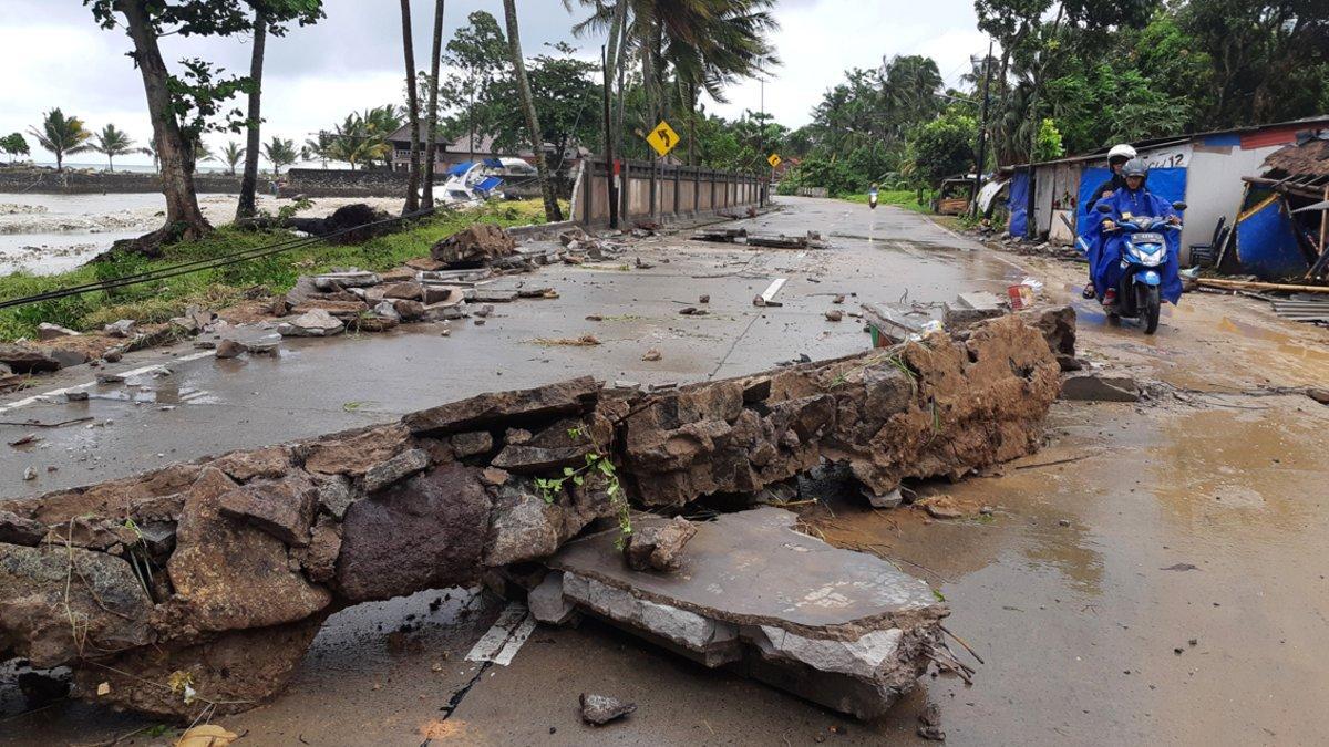 Residents ride a motorcycle past a collapsed wall after a tsunami hit Carita beach in Pandeglang, Banten province, Indonesia, December 23, 2018. REUTERS/Adi Kurniawan