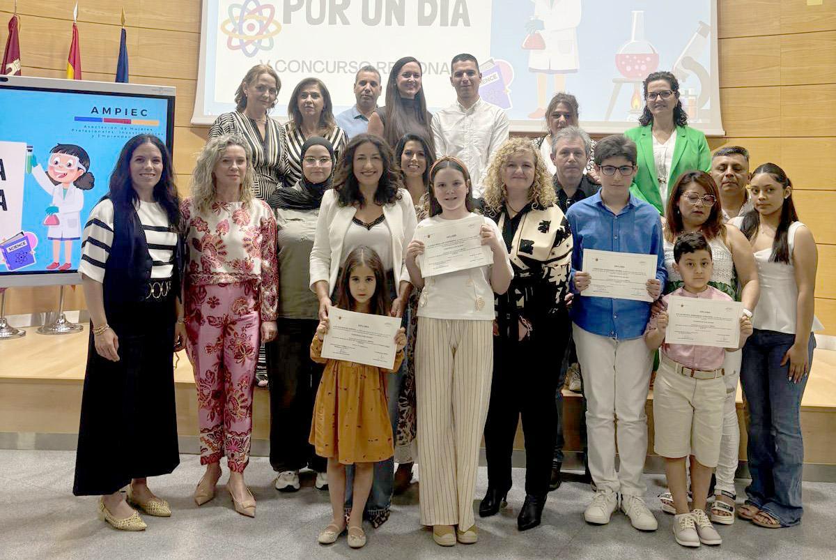 Foto de familia de los ganadores del V concurso escolar regional Científica por un día, en presencia de Ascensión García, Ana Belén Martínez, familiares y docentes