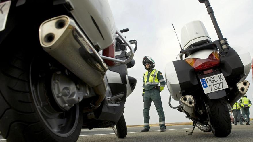 Agentes de Tráfico, junto a dos motos, en un control de los que realiza la Benemérita en las carreteras.