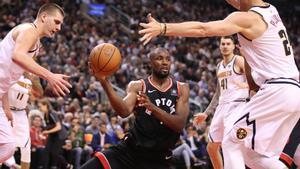 Dec 3, 2018; Toronto, Ontario, CAN; Toronto Raptors forward Serge Ibaka (9) looks to pass as he is guarded by Denver Nuggets forward Mason Plumlee (24) in the third quarter at Scotiabank Arena. The Nuggets beat the Raptors 106-103. Mandatory Credit: Tom Szczerbowski-USA TODAY Sports