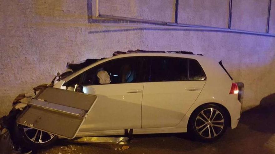 El coche -matrícula 2232 JCN- se subió a la acera, arrastró una señal y se empotró en la pared. // Fdv