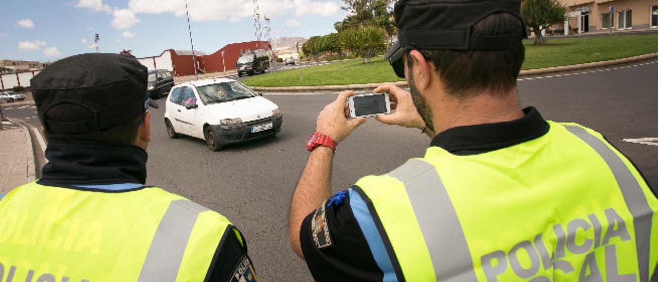 Dos agentes de la Policía Local de Puerto del Rosario utilizando el dispositivo móvil en la avenida marítima, ayer.