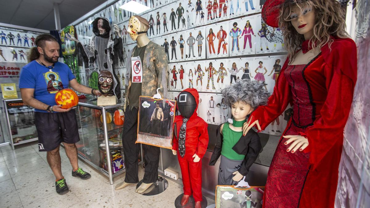 El dueño de una tienda de disfraces muestra varios elementos de Halloween.