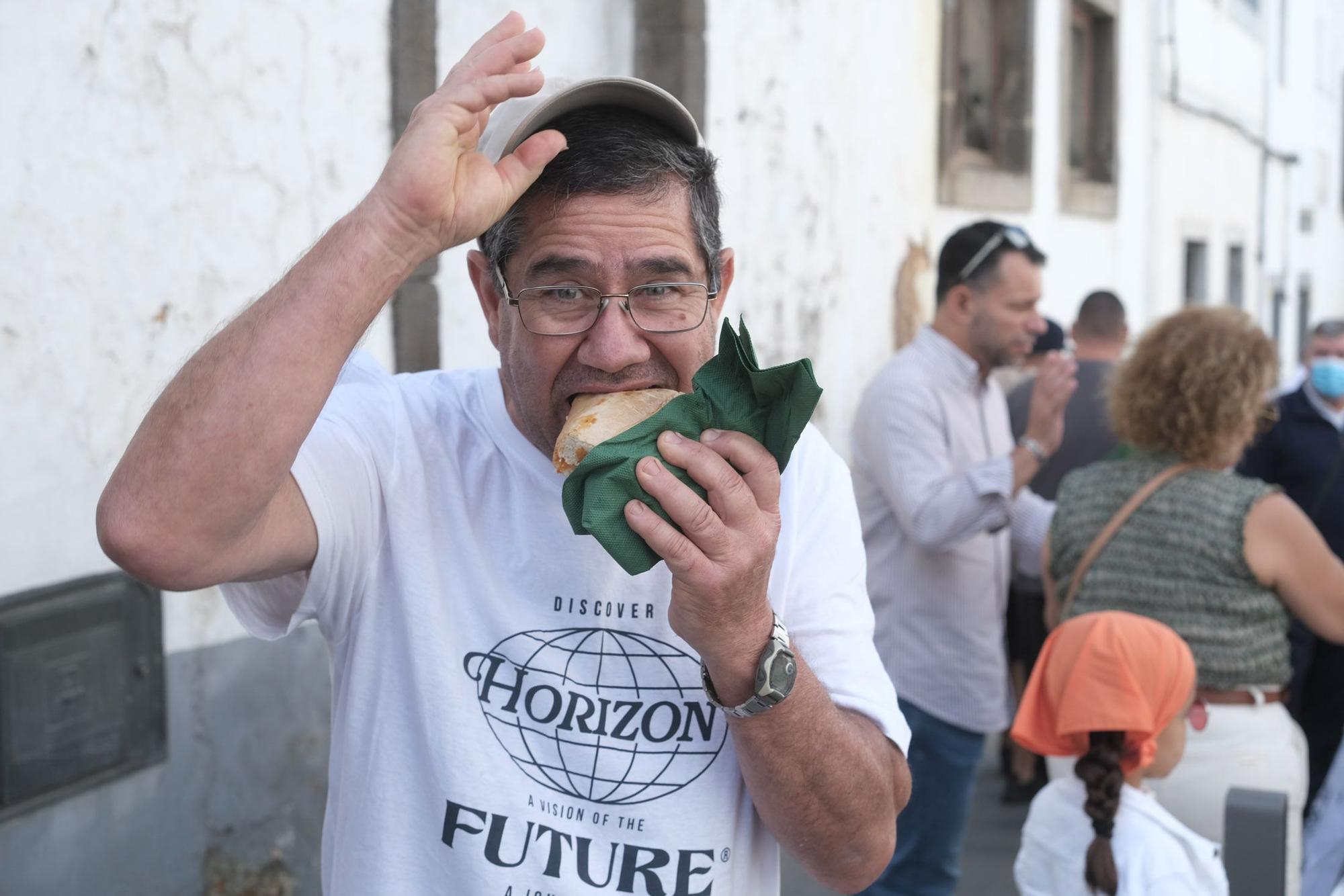 Germán Rodríguez, vecino de Teror, disfruta de un trozo del bocadillo de chorizo gigante.