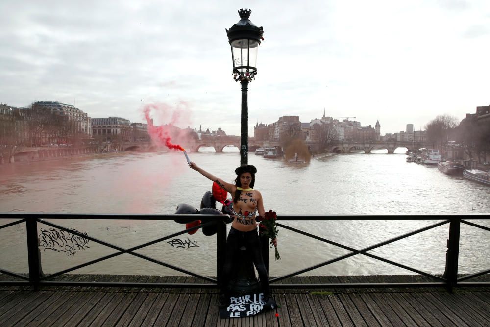 A Femen activist stages an action on the Pont ...