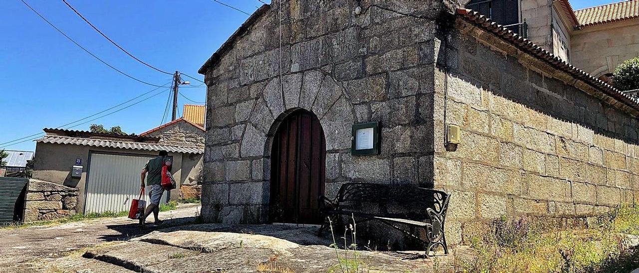 Fachada principal de la capilla, con afloramientos rocosos y una pista asfáltica muy deteriorada |   // G.N.