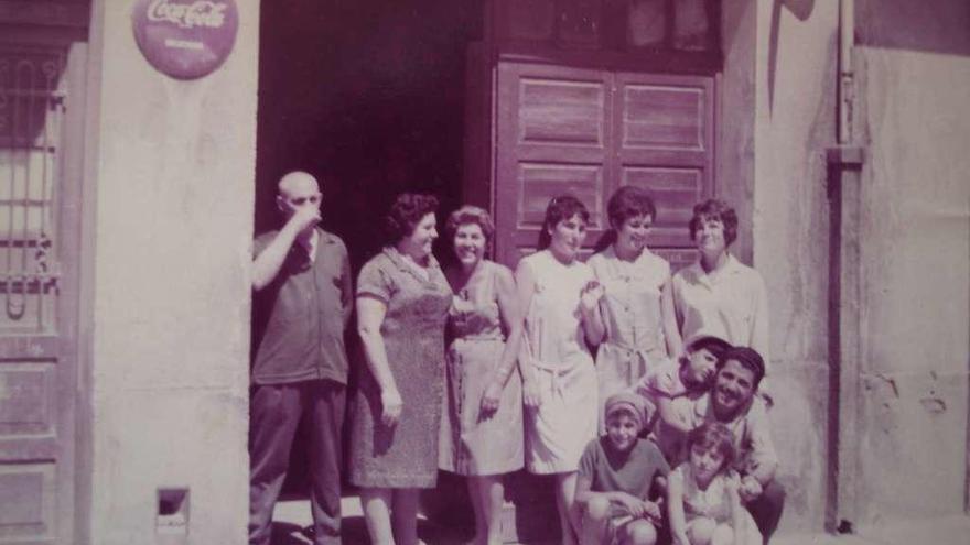 Carmen es la primera por la derecha junto con su familia, en la entrada del bodegón que regentaban en la calle Ángel Senra.