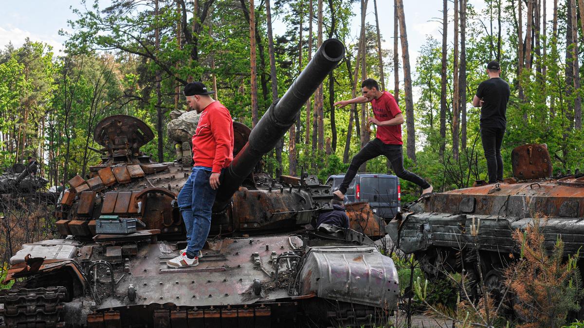 Varios ciudadanos juega e inspeccionan un tanque.