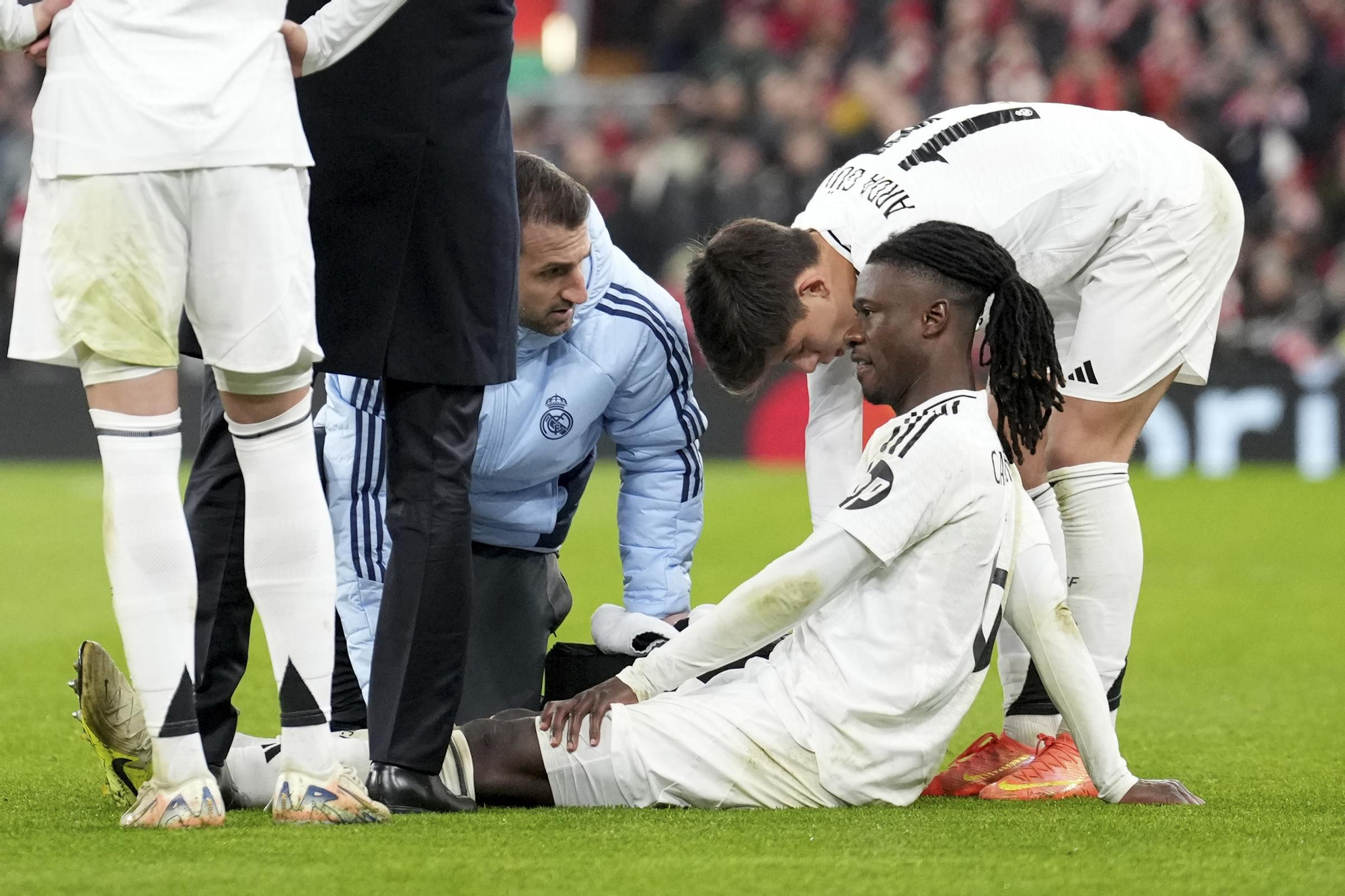 Real Madrid's Eduardo Camavinga is assisted after getting injured during the Champions League opening phase soccer match between Liverpool and Real Madrid at Anfield Stadium, Liverpool, England, Wednesday, Nov. 27, 2024. (AP Photo/Jon Super)