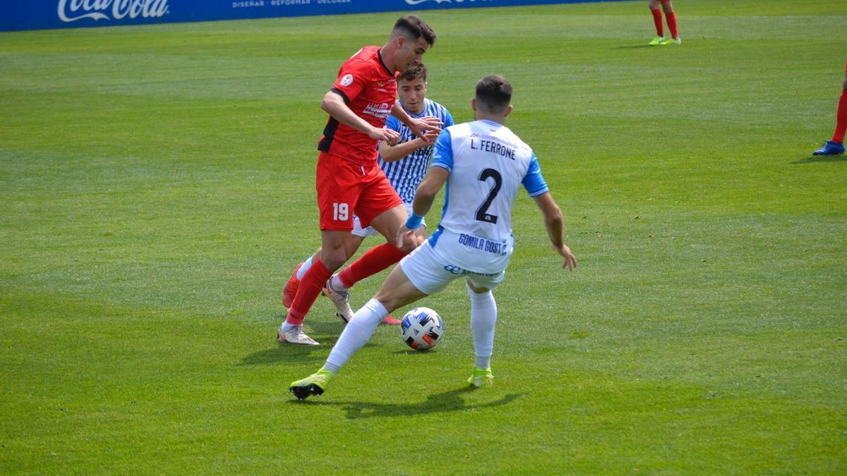 Dos jugadores del Baleares presionan a Jaume Tovar.