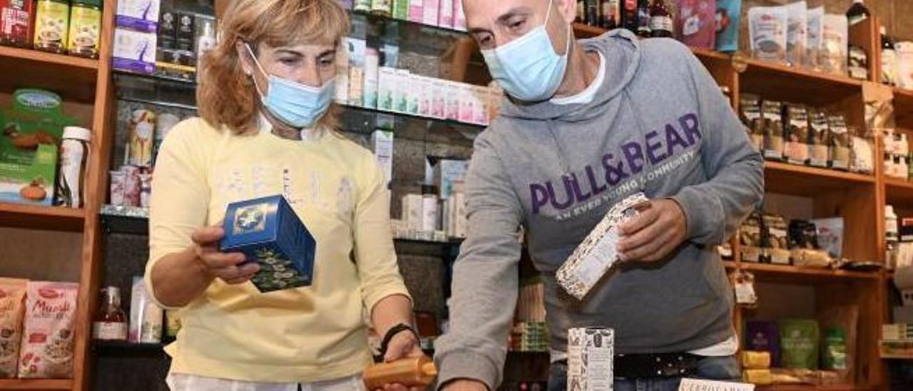 Enrique Rodríguez asesora a una clienta en Ecosabor, tienda de ecológica de referencia desde hace 3 décadas. | // RAFA VÁZQUEZ
