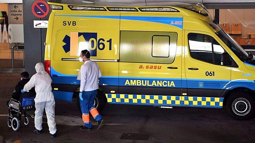 Dos sanitarios trasladan a un paciente de una ambulancia a las Urgencias del Hospital Universitario.