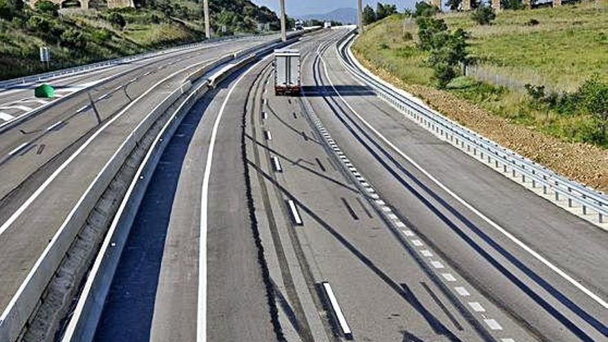 L&#039;autopista al seu pas per Figueres amb els arcs del castell de Sant Ferran al fons.