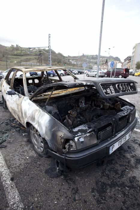 Coche quemado en un aparcamiento en Sama, Langreo