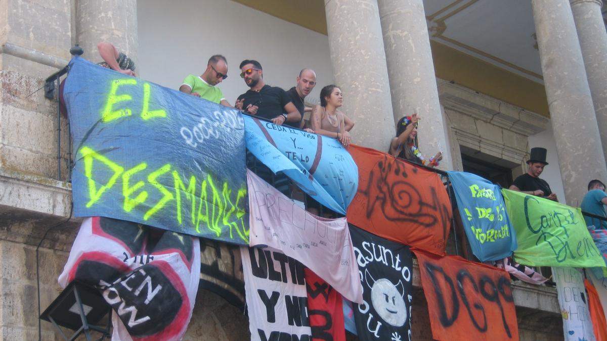 Peñistas cuelgan su bandera en el Ayuntamiento, en una edición anterior de las fiestas