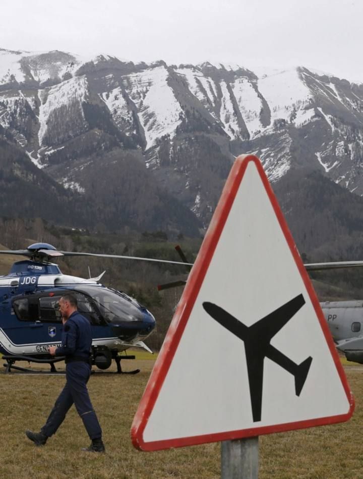 Rescue helicopters from the French Securite Civile and the Air Force are seen in front of the French Alps during a rescue operation next to the crash site of an Airbus A320