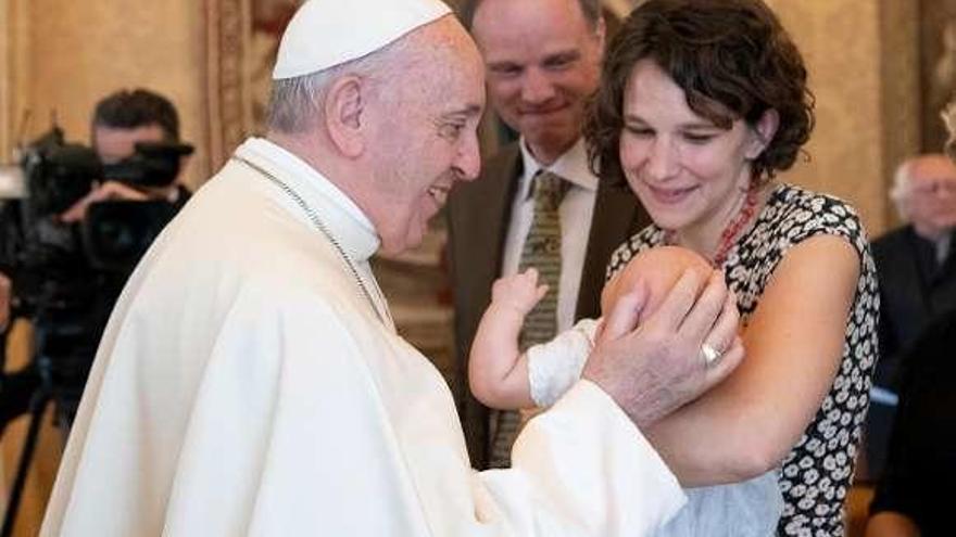 El Papa acaricia a un bebé durante una audiencia celebrada ayer en el Vaticano. // Efe