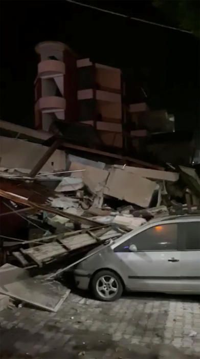 Debris is seen on a car after an earthquake in ...