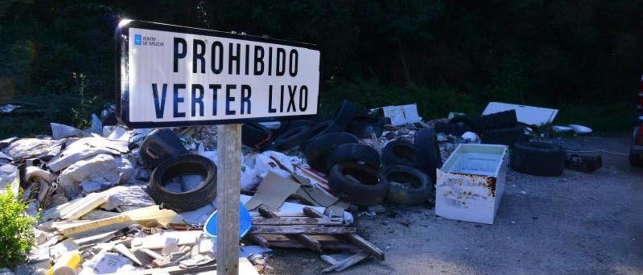 El cartel instalado ante los escombros y ruedas tirados.   | G.N.