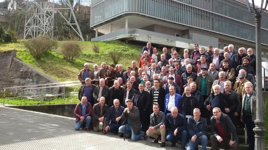 Los antiguos trabajadores del pozo Entrego, con el centro tecnológico y el castillete detrás.